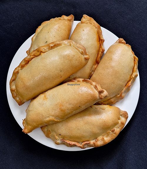 Empanadas are about 7.5 oz. each and are baked.  Vegan options are made with flax meal (as egg-replacer), vegetable filling, and vegan cheese. at The Food Maker in Lexington