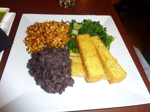 Grilled corn, sautéed greens, polenta fries, black beans  at Candle 79 in New York City