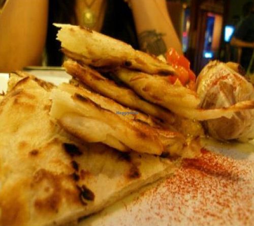 smoked hummus: grilled paratha bread, olives, roasted garlic bulb, red pepper oil. at Candle 79 in New York City