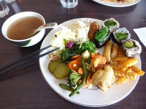 Miso soup and plate of various vegan tastes (wakame, wakame sushi, avocado sushi, vegetables, fried banana, fries, spring rolls, salads) at Sakura Sushi in Uusimaa