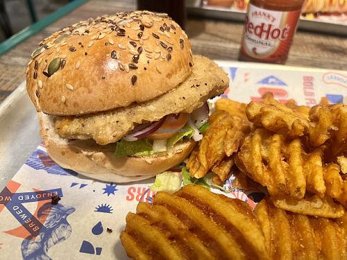 Carolina Tindle Chicken burger with waffle fries   at BrewDog in Horley