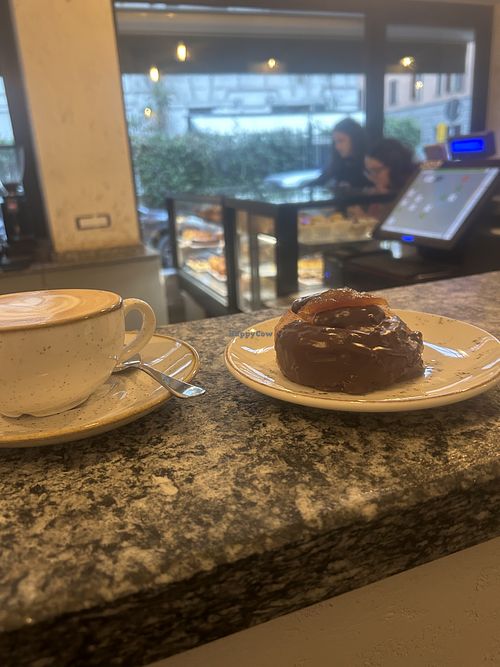 chocolate puff swirl pastry and oat milk cappuccino  at Sisu. in Lombardia