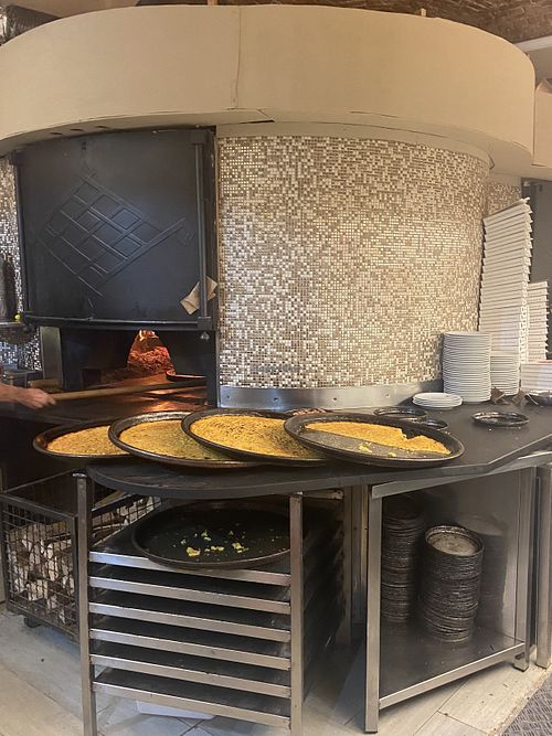 Forno a legna - teglie di farinata  at Dessì in Turin