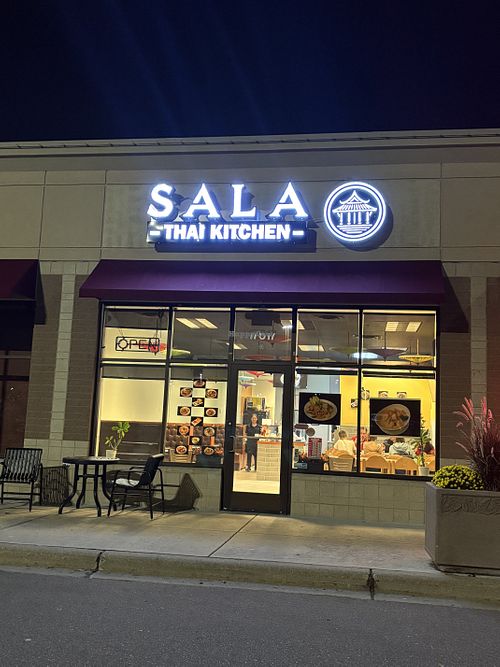 Business outside.  Owner smiling inside.    at Sala Thai Kitchen in Lakeville