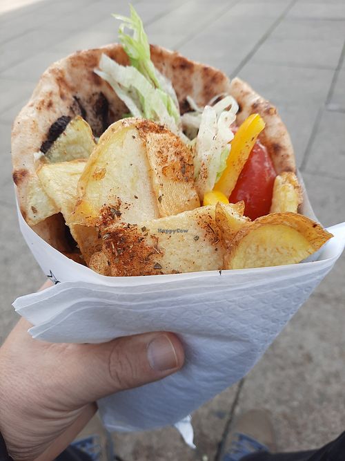 Vegan Greek wrap, generously filled with potatoes and freshly cut salad. at Greekatessen Gyros Brighton Halal in England