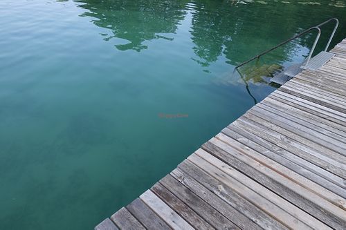 Lake Klopein and its pier at Loving Hut Pension in St Kanzian