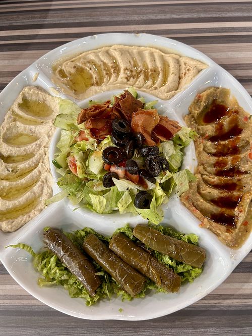 Mixed appetiser plate with hummus, fattoush, two kinds of eggplant dip and the best vine leaves we’ve ever eatenn  at Hadramot Highlands مطعم حضرموت in Pahang