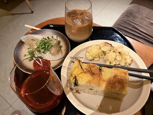 Steamed vegetable dumplings, focaccia and grilled cauliflower with iced tea and oat milk latte   at HKG - Cathay Pacific The Pier Business Lounge - 國泰航空 「玉衡堂」商務貴賓室 in New Territories