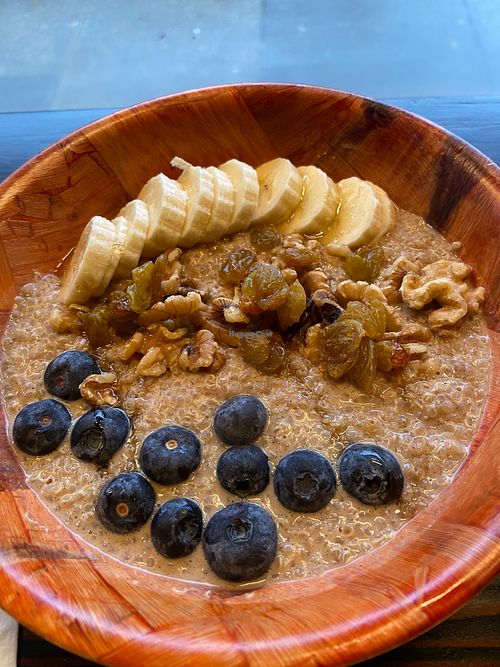 Bear Hug bowl (vegan) with quinoa, almond milk, almond butter, vanilla extract, cinnamon, golden raisins, walnuts, berries, bananas, agave.  at La Osita PDX in Portland