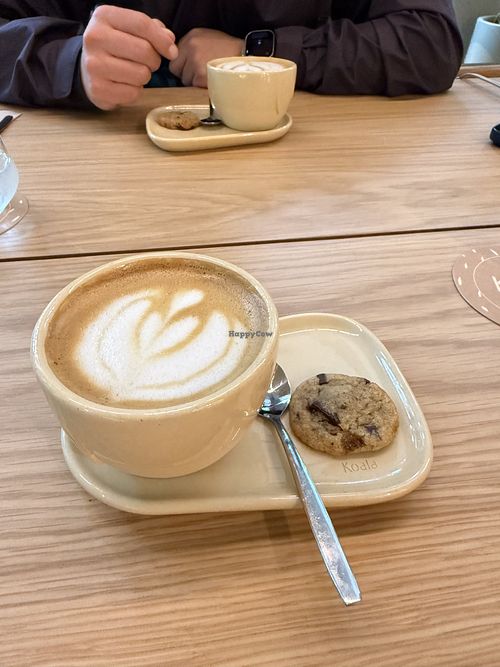 Flat white with oat milk with a complimentary vegan cookie  at Koala in Buenos Aires