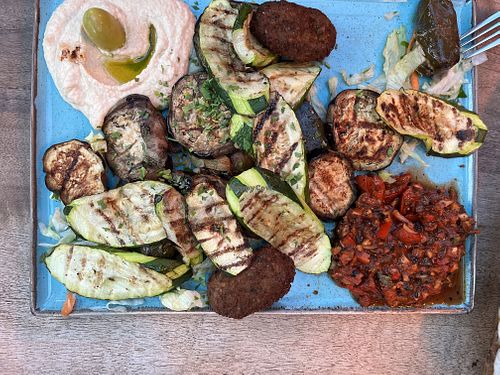 Vegan mezze with houmous, grilled courgette, aubergine, mushrooms, giant olives, ezmal dip, salad  & freshly baked flatbread   at Olive & Thyme in Manchester