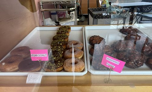 Display case with clearly labeled vegan options  at Sweet Donuts in Olympia