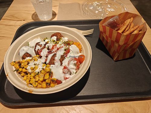 Falafel bowl topped with garlic dressing, with cinnamon sugar pita chips at CAVA - Orlando in Orlando