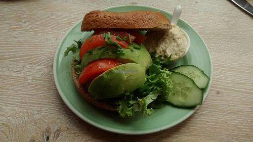 Bagel with avocado, tomato, salad and extra hummus instead of cream cheese at Bagels & Beans - Waterlooplein in Amsterdam