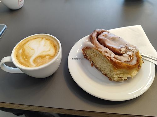 Vegan cappuccino and vegan cinnamon roll at Café DOX  in Prague
