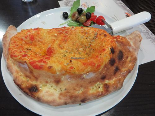 Pizza Speciale Calzone (basil, mushrooms, vegan cheese instead of mozzarella, without ham or salami - please note that vegan cheese is only possible for groups upon advance notice!) at Angelos Via Napoli in Saarbrucken