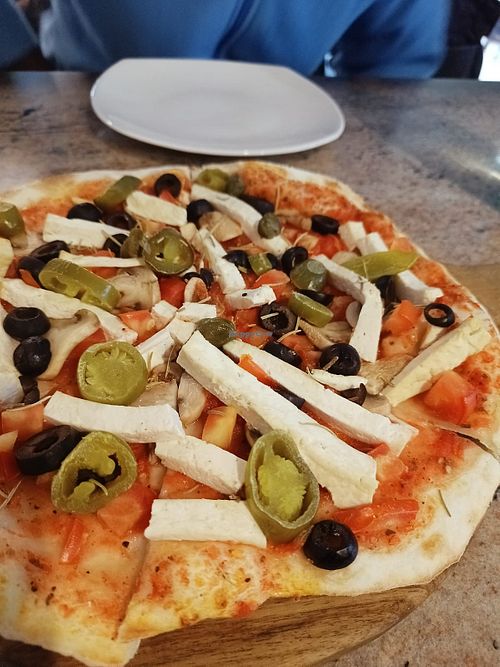 Gregg’s Special Vegan Pizza: olives, tofu, tomato sauce, capers, and mushrooms. Jalapeños optional    at Auro Jars Bakery & Restaurant  in Kuilapalayam