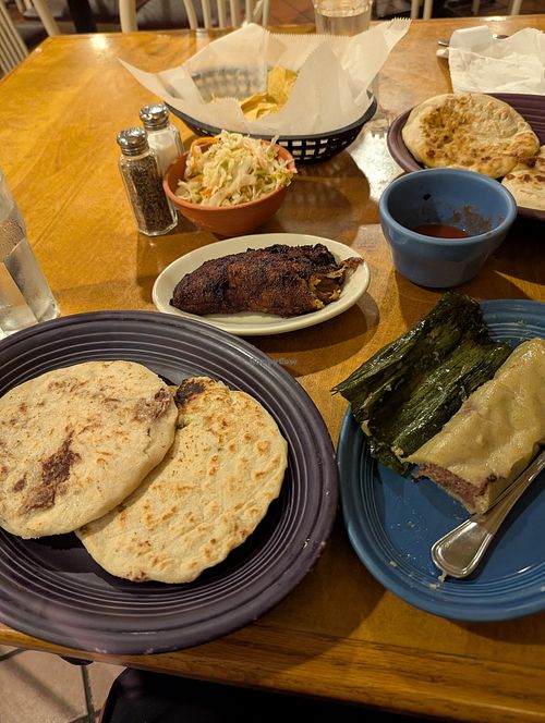 Empanada is the middle plate. Pupusas on the left and tamale on the right. So good 🤤 at Los Chorros Restaurant in Silver Spring