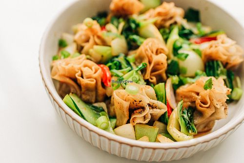 Golden sautéed momos glazed with maple, crisp bok choy, bell peppers and onions, all tossed in a savory house sauce. at Saatvik Cuisine Végé in Magog