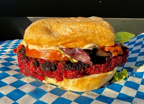 Vegan Bacon Burger

Beet, Lentil, Pistachio
“Burger” topped with Carrot
“Bacon”, lettuce, Tomato, and
house-made lemon tahini
sauce on a red hen kitchen
ciabatta bun at Starry Bites in Eugene