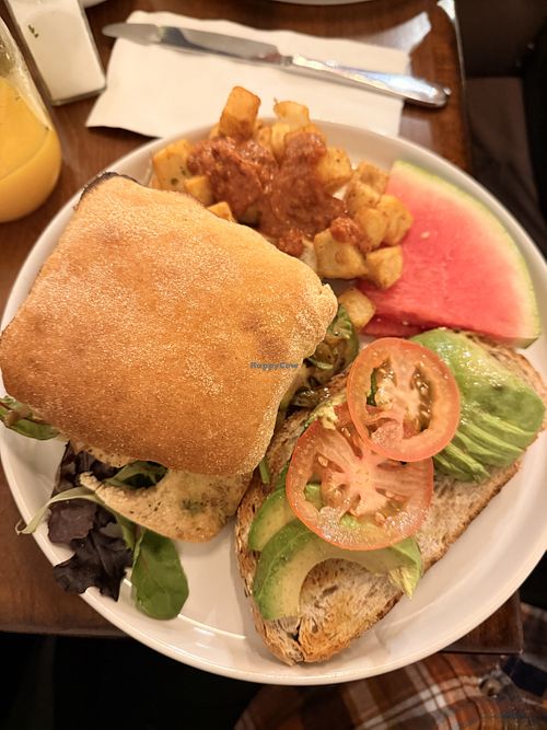 Vegan Sandwich with Roasted Potatoes and an Avocado Toast. Drink: freshly squeezed orange juice (delicious!)  at Brunch Vancouver in Vancouver