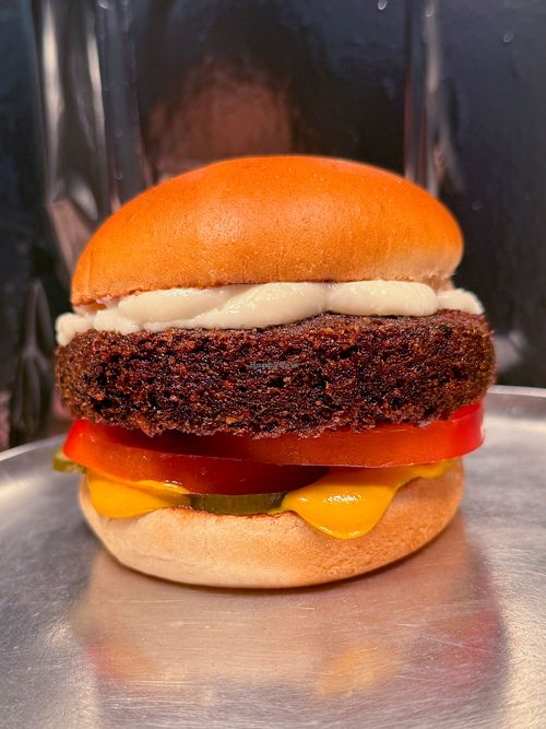 What's in it? Green falafel patty, mustard, vegan garlic aioli, tomato, & pickles on a soft bun. at Atomic Burger in Toronto