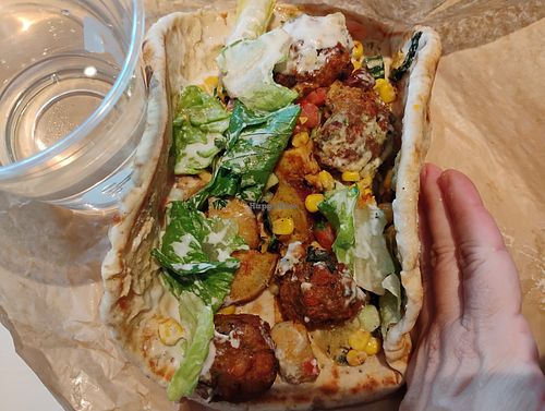 Custom Pita with falafel, white sweet potatoes, corn, tomato & cucumber, romaine, original hummus, eggplant dip, and garlic dressing. at CAVA in Naples