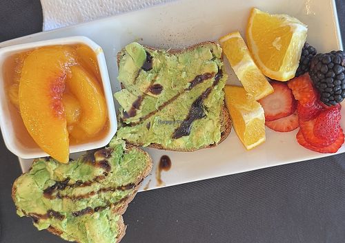 Avocado 🥑 toast with balsamic and a side of fruit  at The Mansion on 17th in Galveston