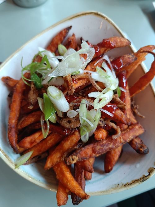 Sweet potato fries with spicy sauce and crispy onions at Garden Kitchen in London