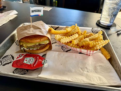 Vegan Impossible Burger (with vegan bun & vegan cheese) served with ketchup and fries at Grindhouse Killer Burgers in Brookhaven