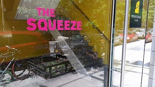 outside signage at The Squeeze Juice - Mercedes Club in New York City