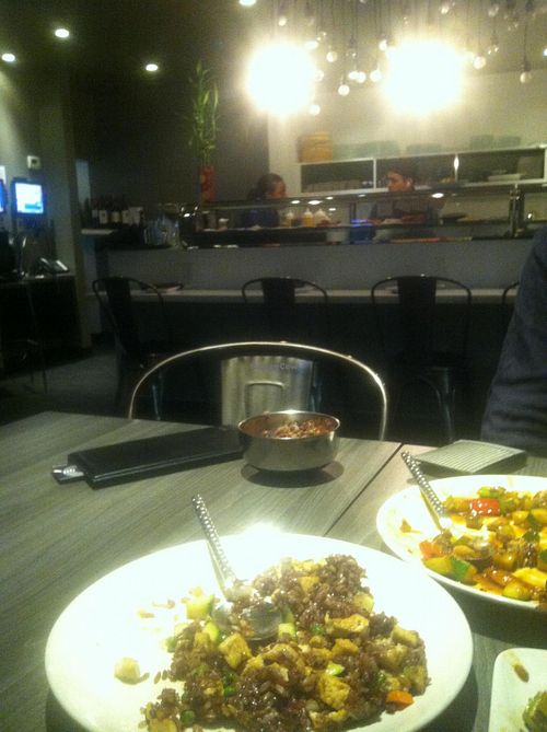 Interior with specialty rice and a peanutty veg dish at Vora in Chicago