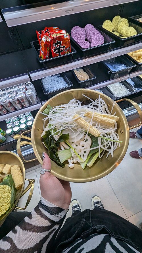 you choose your broth ingredients, then choose which broth you would like and you pay by weight. at Round Belly Hotpot  in Markham