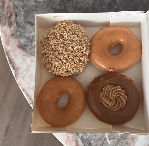 Plain, Apple custard crumble, and Biscoff crème  at Krispy Kreme in Brisbane