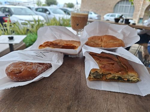 Spinach pie, bagel with olives, kind of a dough, sweet pastry with vegan "milk" at Aroma Cafe in Nafplio