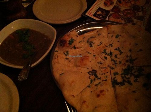 Bhartha Dip - Clay oven roasted eggplant blended with spices and cooked with peas, tomatoes, and served with naan bread at Annapurna Cafe in Seattle