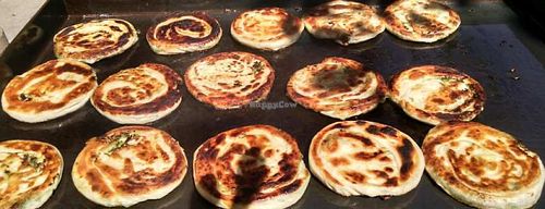 Green onion cakes on the grill out on the sidewalk. Something that is done during the summer months for the Saturday Farmer's Market that happens directly in front of the downtown store. at Earth's General Store Deli in Edmonton