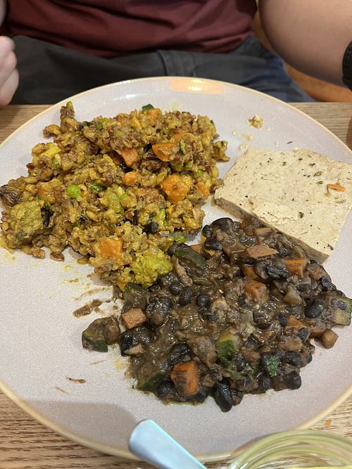 Tofu, marinated beans, vegan paella  at Amrita Caffè & Bistrot in Milan