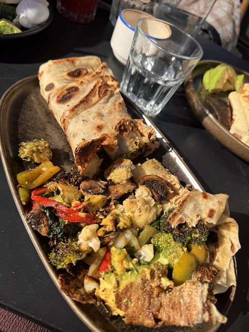 Delicious grilled vegetable, hummus and avocado roti- amazing.   at Manu's Cafe and Restaurant in St Kilda