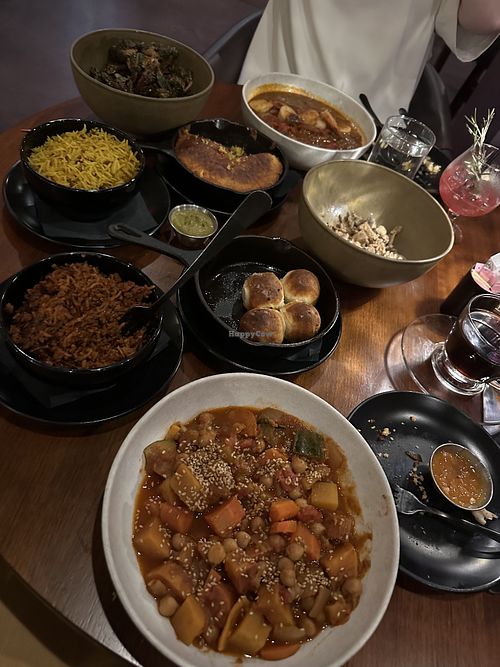 The jollof rice is insane actually, and I wish I could remember the name of the stew dish I had, but it was also phenomenal!! The Brussels in the far left corner were also 10/10.   at Okan Bluffton in Bluffton