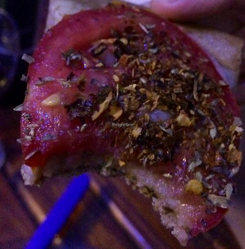 Puzza so good we couldn't get a photograph without taking a bite first.  at Pizza Vegana - Fitz Roy in Buenos Aires