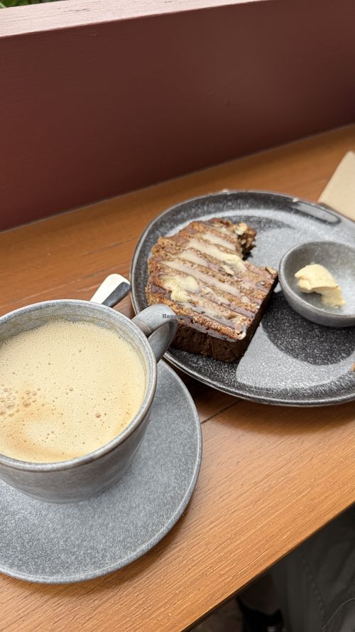Oat milk latte with vegan banana bread and maple infused nuttlex  at Rich Market Cafe & Nursery in Abbotsford