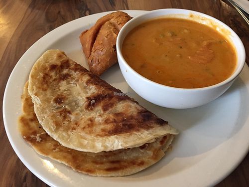 Curry with roti and samosa at Mantra Lounge in Carlton