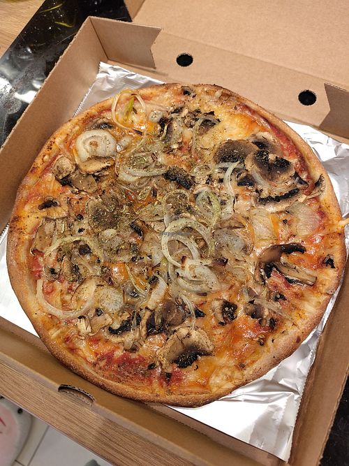 The "Swedish" pizza, with vegan cheese replacing the dairy cheese base and parmesan. Features garlic, mushrooms, onions and herbs. at Davardi's Pizza Bar in Worsley