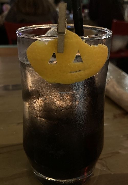 Halloween Special: Black Magic, a non alcoholic drink coloured black with spooky vibes. I love the tiny clementine pumpkin!  at MeeT on Main in Vancouver