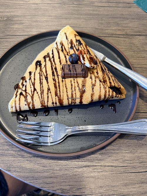 A customized vegan sweet crêpe with fresh strawberries, bananas, and blueberries with vegan Hershey’s chocolate with almonds inside and a basic vegan Hershey’s chocolate on to at Bearry Sweet in South Lake Tahoe