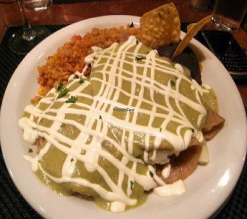 green enchiladas: Corn tortillas stuffed with garlic mashed potatoes, smothered in a green tomatillo sauce and drizzled with soy cheese at Karyn's Cooked in Chicago