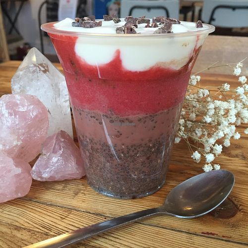 Cacao Chia Pudding made with Almond Mylk, topped with Vegan yogurt, raspberry compote & cacao nibs.  at Love Juice in Manchester