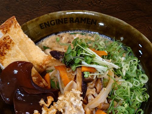 SHINJUKU GB - VEGAN / Signature ramen topped with savory ginger-sautéed veggies, rich mushroom blend, and roasted black garlic oil. / Allergy info: Wheat, Orange, Soy, Buckwheat at ENGINE SHINJUKU RAMEN in Tokyo