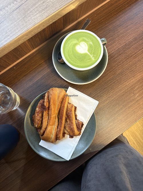 Soy matcha and vegan sugar cinnamon pastry  at UP Coffee (Café) in Munich